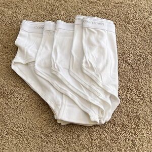 NWOT! Calvin Klein Mens SZ 38, set of four white briefs with waist logo.